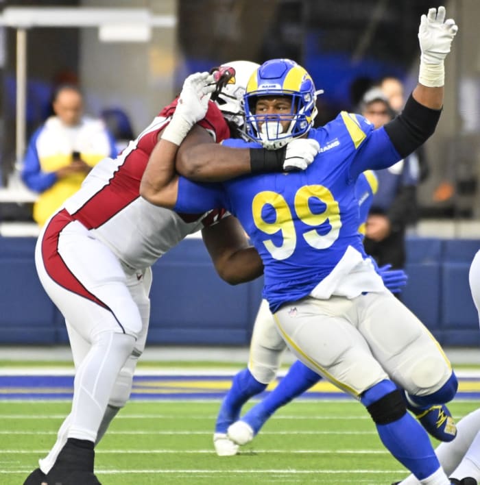 Los Angeles Rams defensive tackle Aaron Donald (99) slips past Arizona Cardinals guard Lecitus Smith (54) to get to quarterback Colt McCoy (not pictured). Mandatory Credit: Robert Hanashiro-USA TODAY Sports